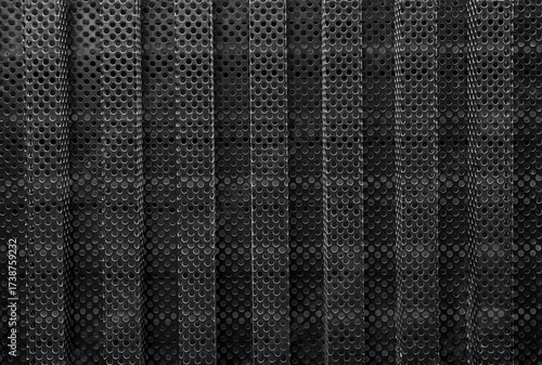 Black metal surface with a grid of holes