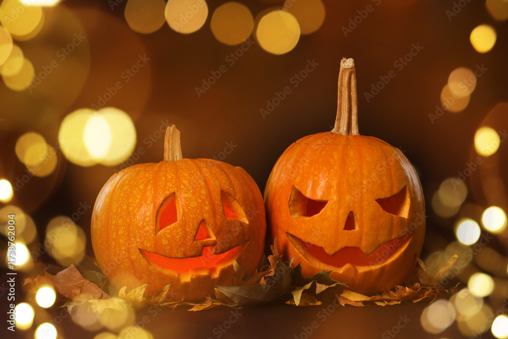Fototapeta premium Halloween celebration. Pumpkins with carved creepy faces, bokeh effect