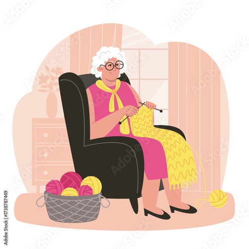 Elderly woman knitting in a chair with yarn basket