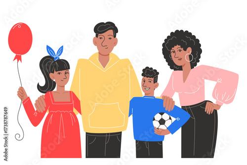 Family posing for a picture with a balloon and soccer ball