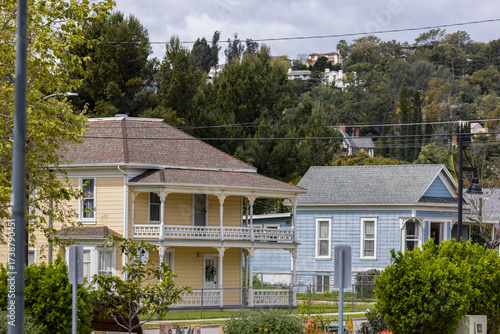 Cloudy afternoon sun shines on historic homes in the heart of downtown Santa Paula, California, USA.