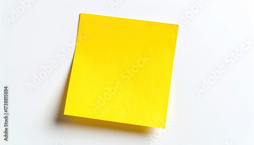 Bright yellow sticky note on clean white surface beckons for your important messages, ideas, to-do lists, and creative brainstorming sessions