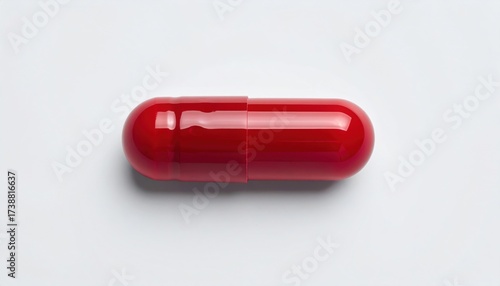Vibrant red capsule isolated on a pristine white background, perfect for pharmaceutical, healthcare, and medical concepts, conveying health and wellness.