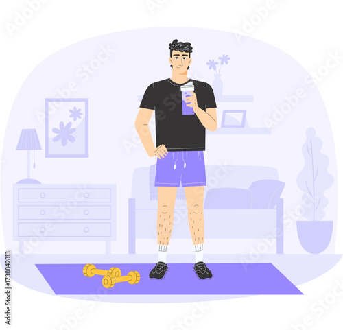 Man in black tshirt and purple shorts holding a drink on a mat