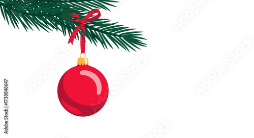 A festive red bauble hangs from a fir tree branch tied with a ribbon for christmas celebrations.
