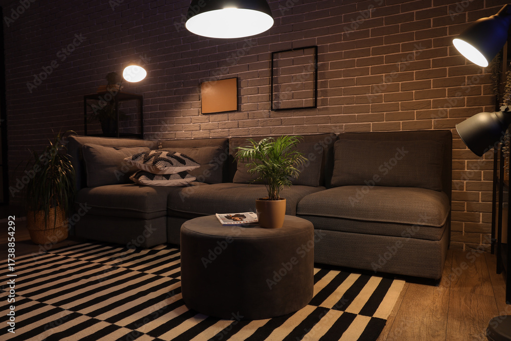 © Pixel-Shot - Cozy sofa, coffee table and glowing lamps in interior of living room at night © Pixel-Shot - Cozy sofa, coffee table and glowing lamps in interior of living room at night