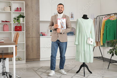 Happy male stylist holding ...