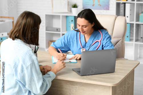 Happy young female doctor w...