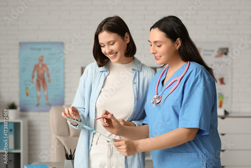 Happy young female doctor w...