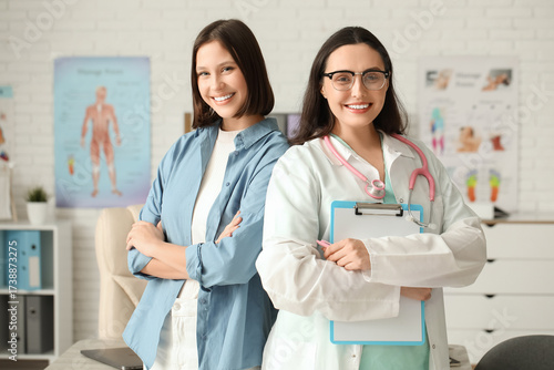 Happy young female doctor w...