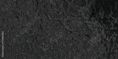Abstract dark textured background resembling geological forms and grungy surface with subtle highlights