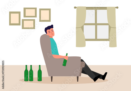 Drunk young man sitting on sofa with alcohol bottles on the floor. Alcoholism.