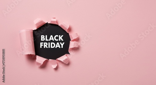 A circular tear in pink paper reveals a black center with the white text BLACK FRIDAY inside
