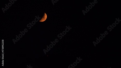 A crescent moon is in the summer night sky in Fukuoka city, Japan. without sounds