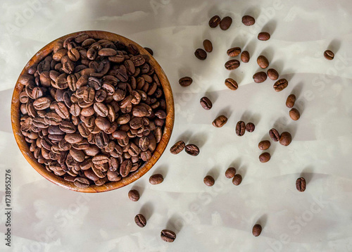 coffee beans in a wooden bowl on a marble table
