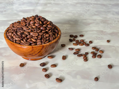 coffee beans in a wooden bowl on a marble table
