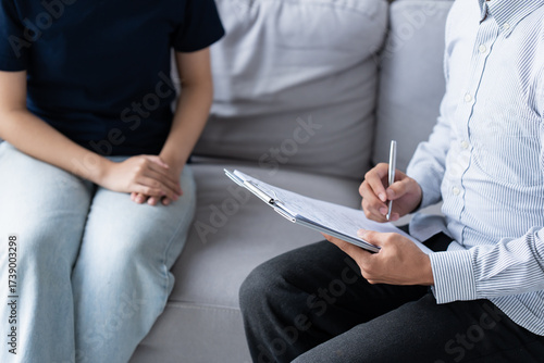 sad female sitting on sofa Patient discussing mental health issues with psychologist. depressed asian woman mental health treatment