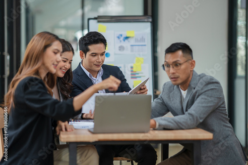 Wallpaper Mural Group of Asian businesspeople sits down for a business investment planning meeting.	 Torontodigital.ca