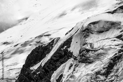 A close-up of a mountain peak in bad weather, leading to the death of climbers in windy weather, snow-capped peaks in the clouds