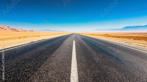 An Empty Desert Highway Stretching into the Horizon Under a Vast Sky