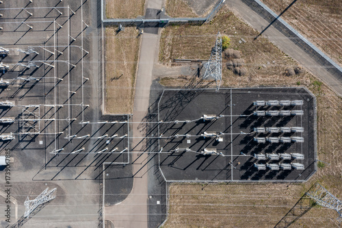 Aerial drone picture of large electric power substation and high voltage power lines in Hillsboro Oregon, showing transmission towers, transformers, and distribution infrastructure from above