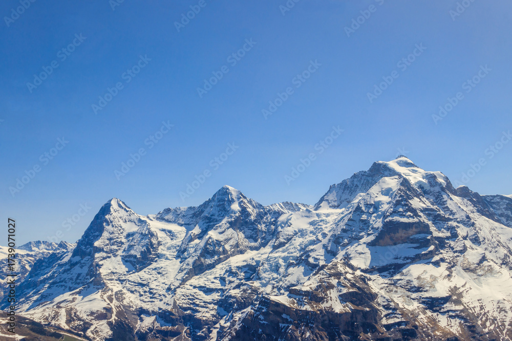 Obraz premium View of three famous Swiss mountain peaks Eiger, Monch and Jungfrau in the Bernese Oberland in Switzerland
