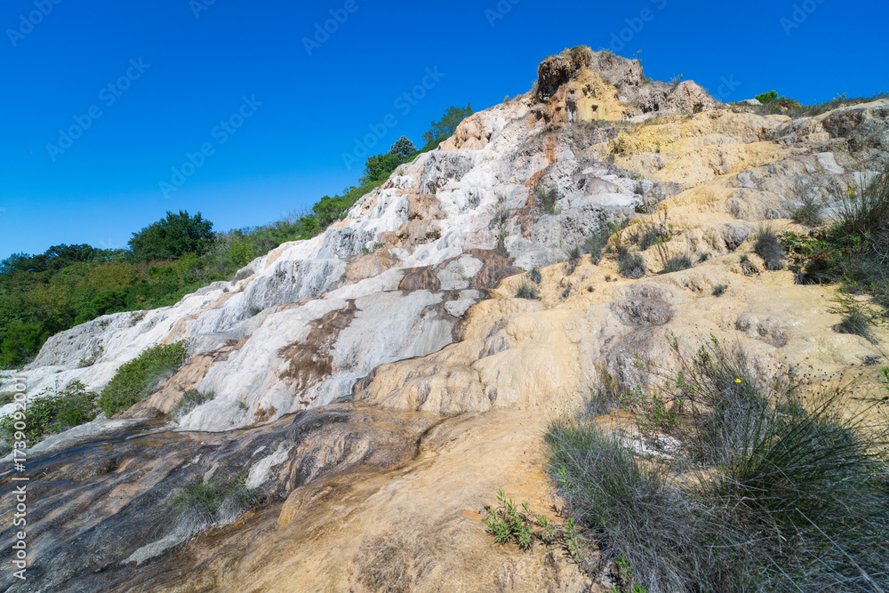Obraz premium Parco naturale dei Mulini, public park with hot springs and dismantled system of grain mills at Bagno Vignoni, Val d'Orcia town in the province of Siena, Italy