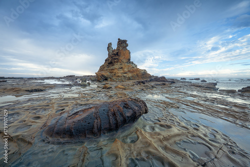 Stormy coastal landscape with eroded cliffs, rock formations and tidal pools in Victoria, Australia