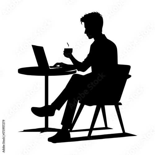 Silhouette of a man working on a laptop at a desk