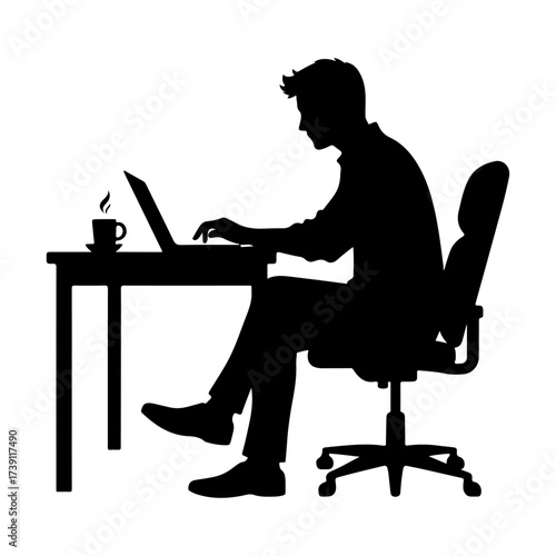 Silhouette of a man working on a laptop at a desk