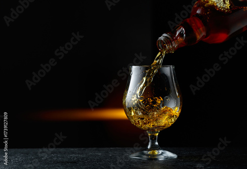 Brandy being poured into a glass.