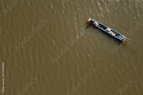 Small Fishing Boat on Murky Water