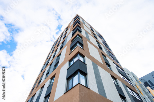 Photography A modern apartment building with a geometric façade, corner windows, a combination of light and warm tones, clean lines, and a minimalist design