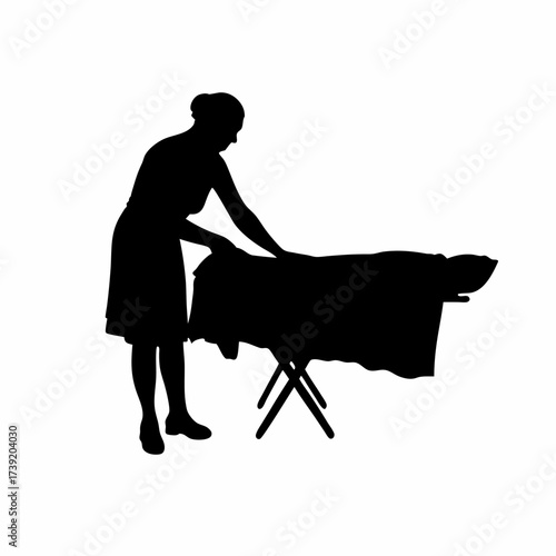 Silhouette of a woman folding a bedsheet isolated on white background