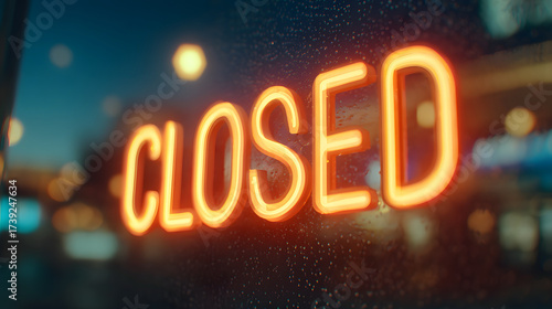 Glowing neon Closed sign on a dark city street at night.