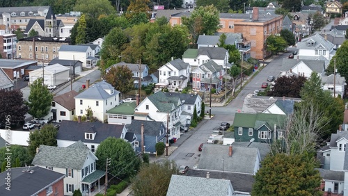 Aerial view of rooftops and tree canopies interweave in a dense urban tapestry, punctuated by the occasional church spire, Carbondale, Pennsylvania, United States.