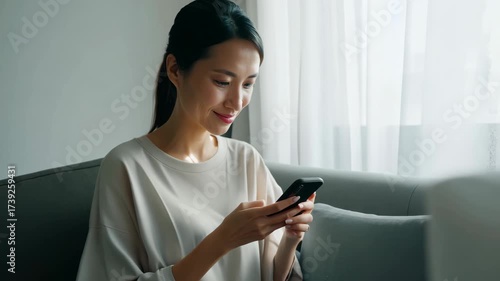 A Woman Engaged in Digital Connection: Captivating Moments of Interaction While Using Her Smartphone in a Cozy, Sunlit Environment
