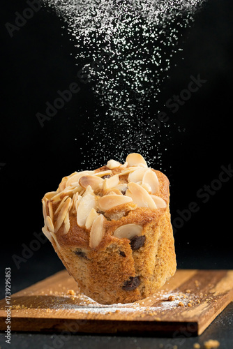Almond muffin bake sprinkled with flour and sugar, giving it a delicious feel.