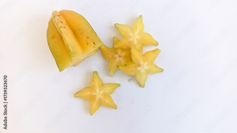 Fototapeta premium sliced ripe yellow starfruit in white background