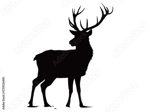 A robust deer silhouette stands firmly on its legs, showcasing impressive antlers against a backdrop of fading light. The scene captures a moment of calm in nature.