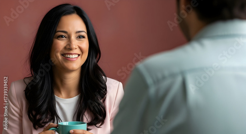 Businesswoman enjoys coffee during informal meeting in coworking space creating connections and building trust while strengthening rapport through positive nonverbal cues