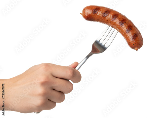 a hand holding a sausage on a fork for a meal
