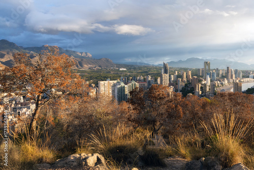 Panoramic view of a modern coastal city with high-rise buildings along the Mediterranean Sea.