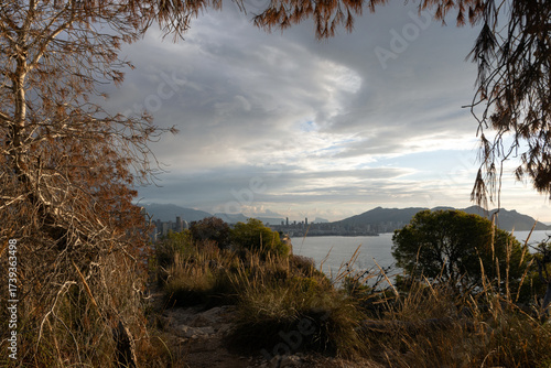 Panoramic view of a modern coastal city with high-rise buildings along the Mediterranean Sea.