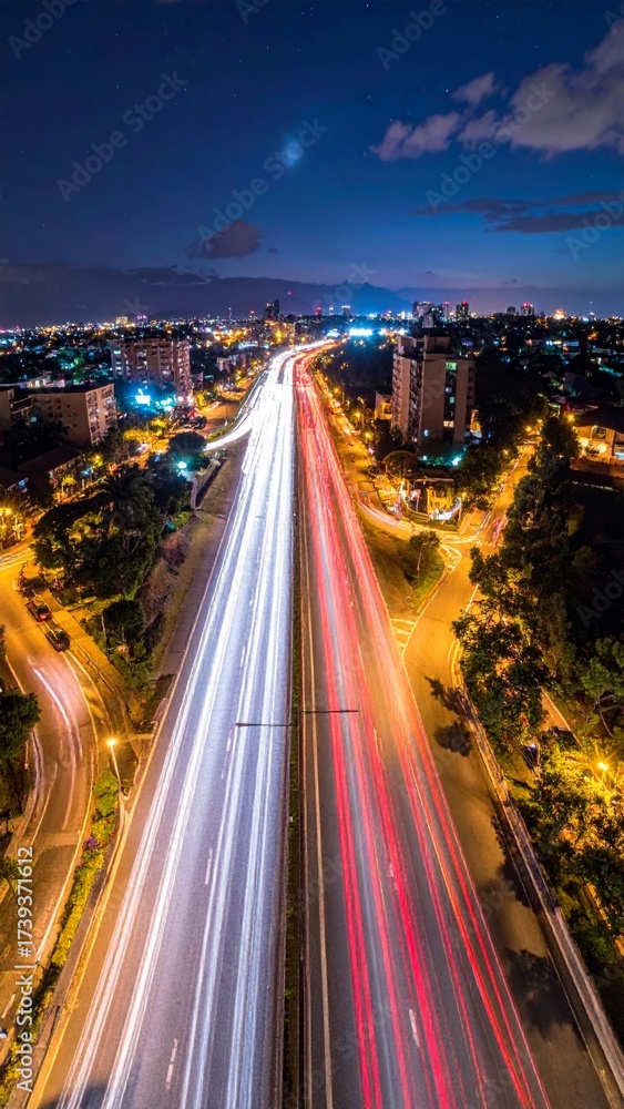 Obraz premium Neon city lights illuminate the blur of night traffic on a busy Hong Kong highway
