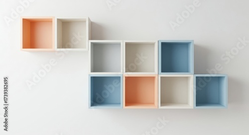 Modern geometric wall shelving with pastel colored cubes arranged artfully on a white background