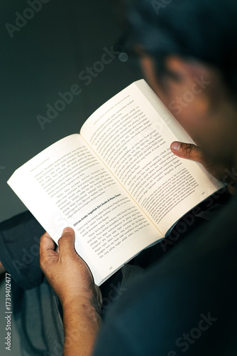 Wallpaper Mural A quiet page can change your entire world - Man Reading a Book Indoors Torontodigital.ca