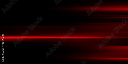 The effect of red light in fast motion on a black background. blurred abstract background with long exposure. neon light
