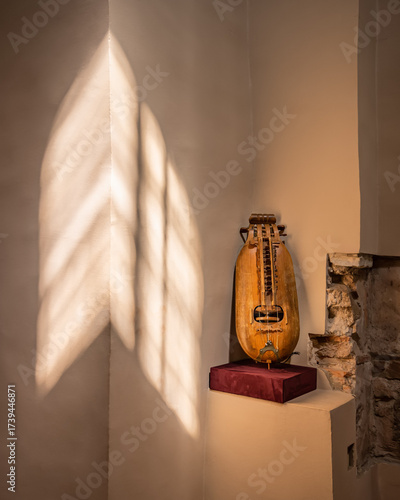 Ancient Ukrainian hurdy gurdy string instrument with sunlight and shadows