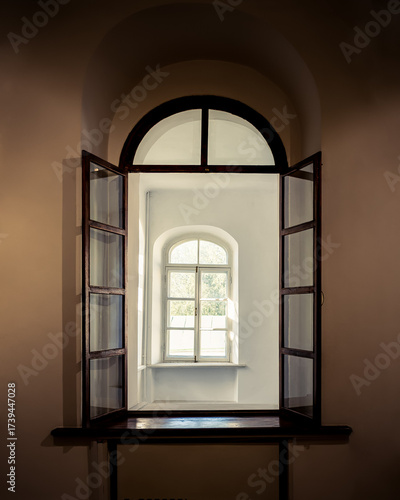 Open arched window with view to another window